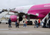 Passengers are boarding a Wizz Air plane