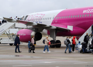 Passengers are boarding a Wizz Air plane