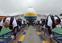 Восемь спортсменов тянут самолет Ан-225 Мрия