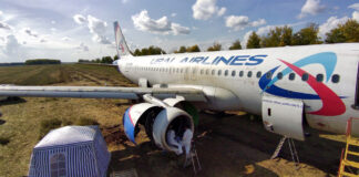 Инженеры осматривают двигатель Airbus A320 RA-73805 "Уральских авиалиний" после посадки в поле