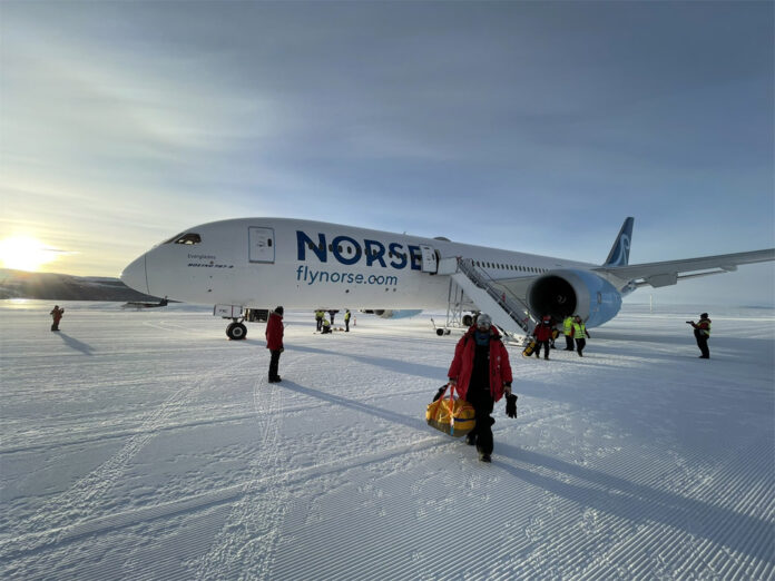 Исследователи сходят с борта самолета Boeing 787-9, который приземлился на ледяной полосе Troll Airfield в Антарктиде