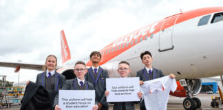 Европейский лоукостер пожертвует школам форму экипажей Школьники с элементами формы экипажей на фоне самолета easyJet